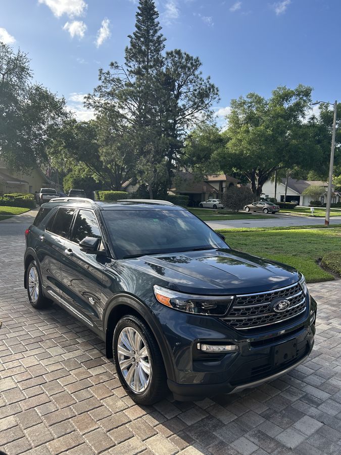 Dark blue Ford Explorer King Ranch finished on a paver drive