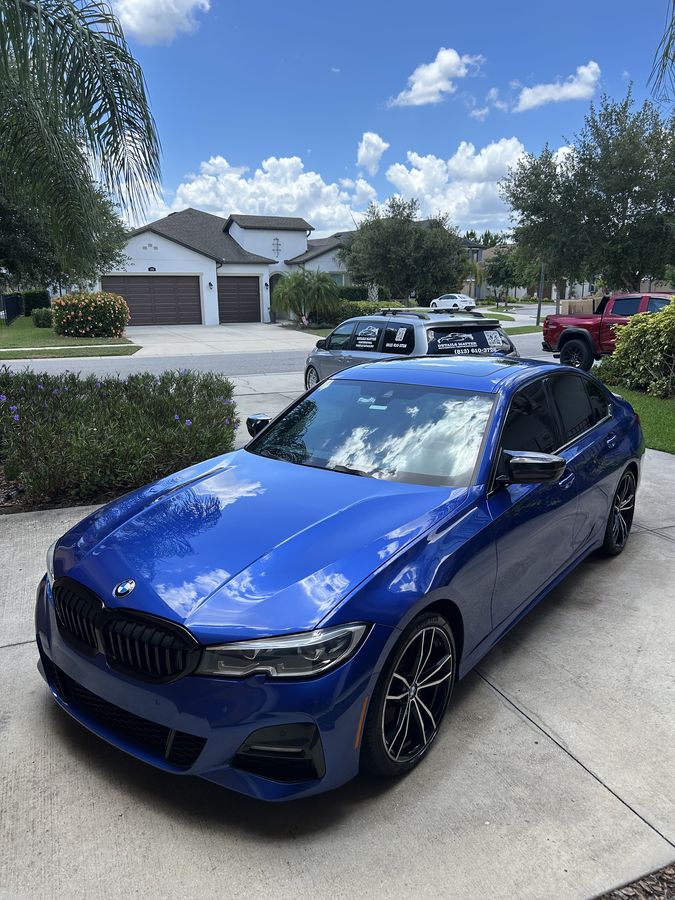 BMW 3 Series in Portimao blue, finished on a driveway
