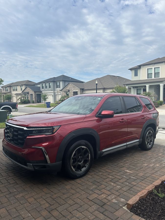 Red Honda Pilot HPD, finished, on a driveway